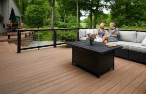 Modern composite deck with outdoor seating and cable railings overlooking a landscaped backyard